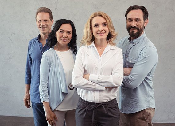 Confident business team posing together in casual office attire.